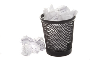 Rubbish basket full of white crumpled papers